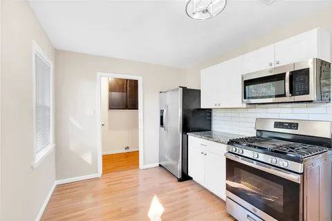 a kitchen with stainless steel appliances a stove microwave and refrigerator