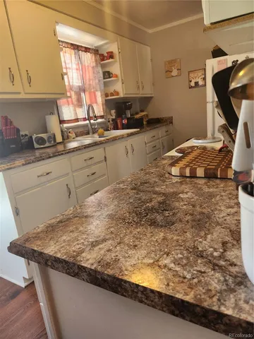 a kitchen with sink window and cabinets