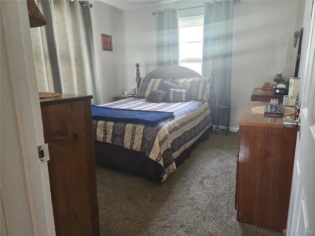 a bedroom with a bed and a mirror