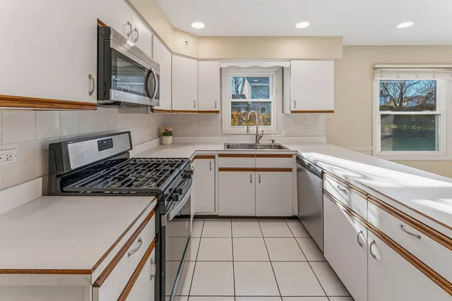 a kitchen with a stove sink and cabinets
