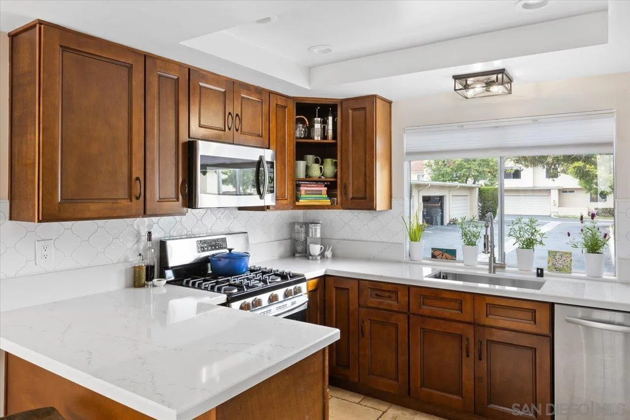 1763 Edgefield Lane Encinitas, CA 92024 - Photo 12 of 31 a kitchen with a sink a stove and a window