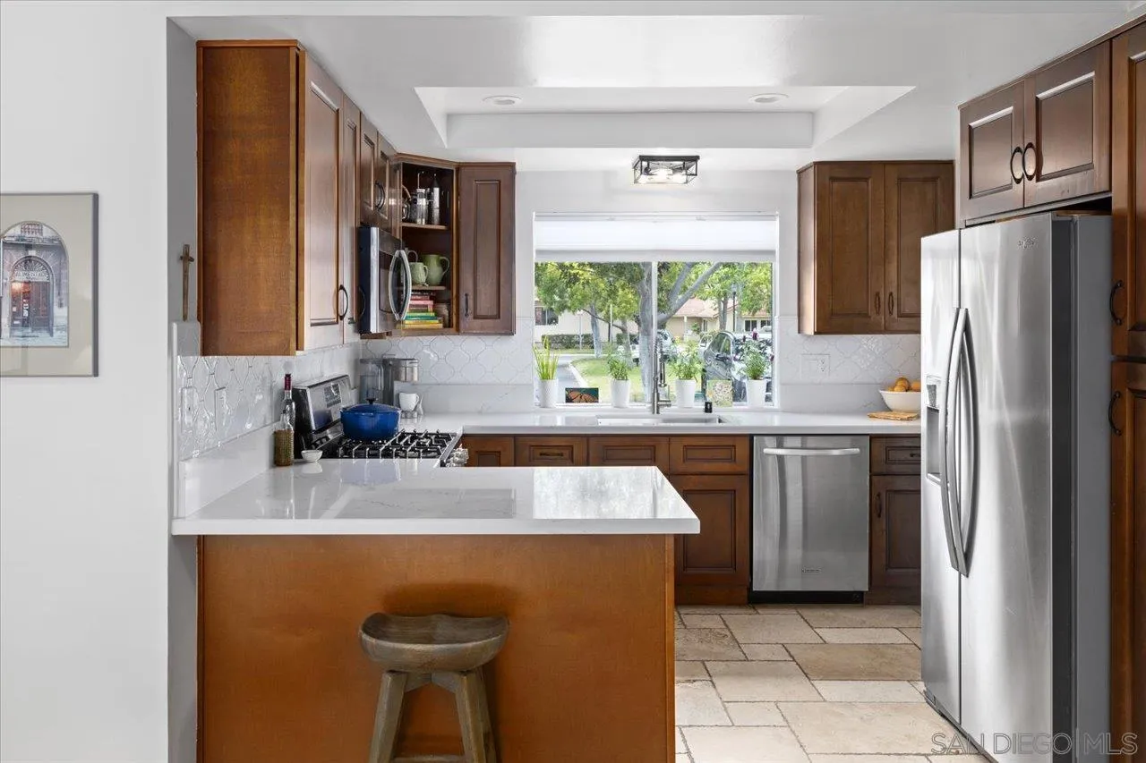 1763 Edgefield Lane Encinitas, CA 92024 - Photo 13 of 31 a kitchen with stainless steel appliances granite countertop a refrigerator and a sink