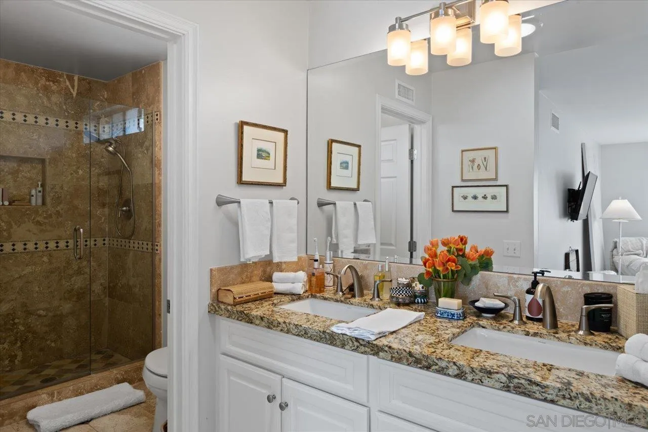 1763 Edgefield Lane Encinitas, CA 92024 - Photo 20 of 31 a bathroom with a granite countertop sink a toilet and a shower
