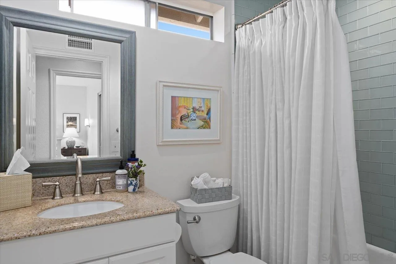 1763 Edgefield Lane Encinitas, CA 92024 - Photo 23 of 31 a bathroom with a granite countertop sink vanity mirror and toilet