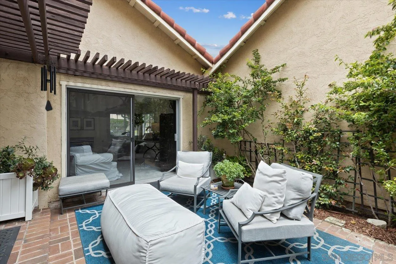 1763 Edgefield Lane Encinitas, CA 92024 - Photo 25 of 31 a view of a patio with couches table and chairs and potted plants