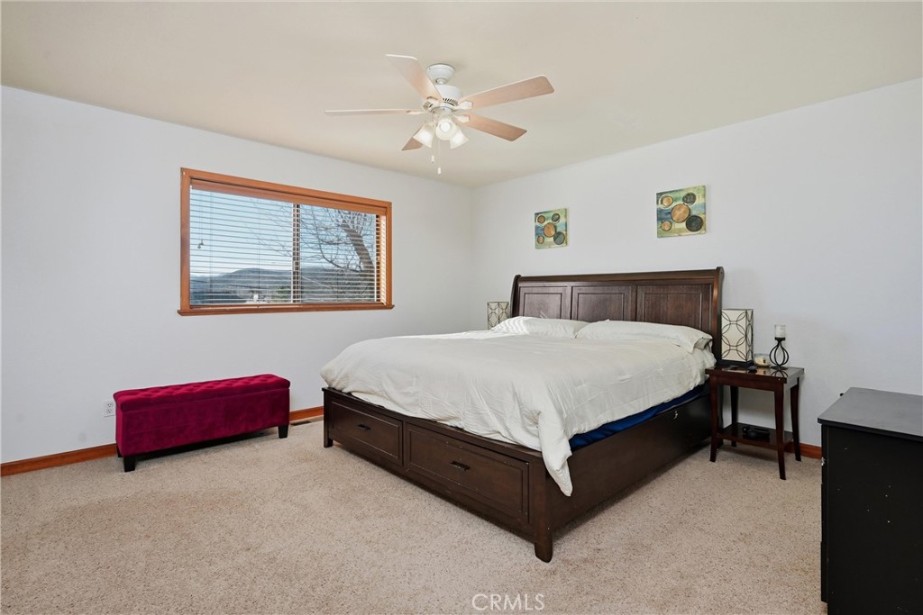 18712 Hidden Valley Road Hidden Valley Lake, CA 95467 - Photo 16 of 38 a bedroom with a bed and a chandelier