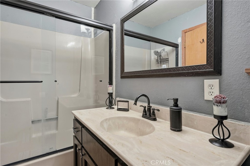 18712 Hidden Valley Road Hidden Valley Lake, CA 95467 - Photo 25 of 38 a bathroom with a sink a vanity and a mirror
