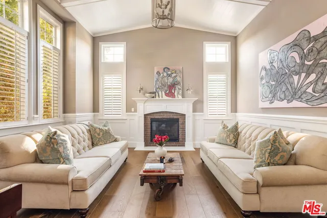 a living room with furniture fireplace and window
