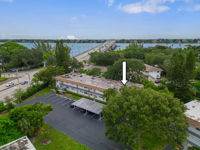 an aerial view of a house with a garden and lake view