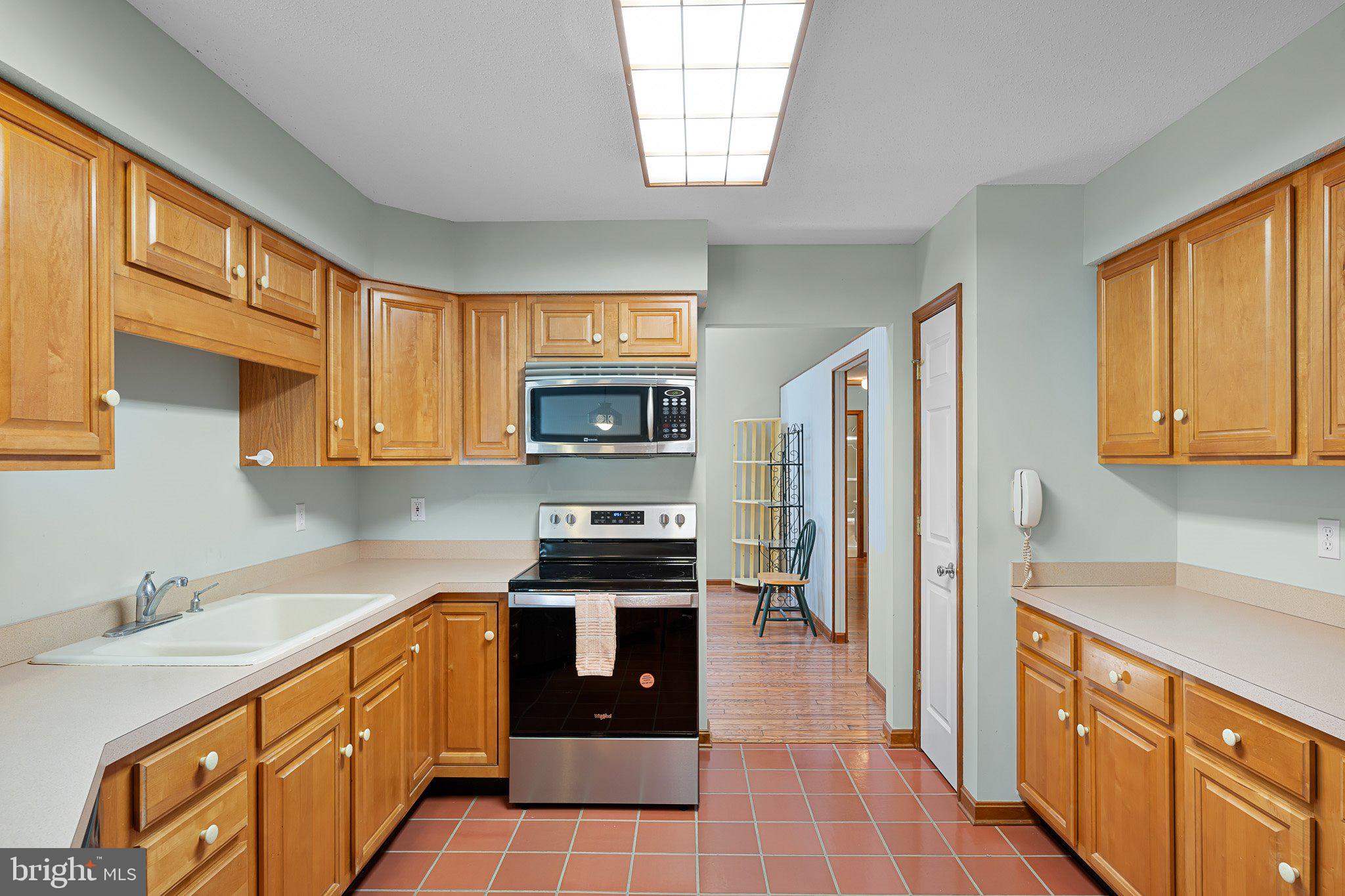 485 Bethany Loop Bethany Beach, DE 19930 - Photo 12 of 40 a kitchen with stainless steel appliances a stove sink refrigerator and cabinets