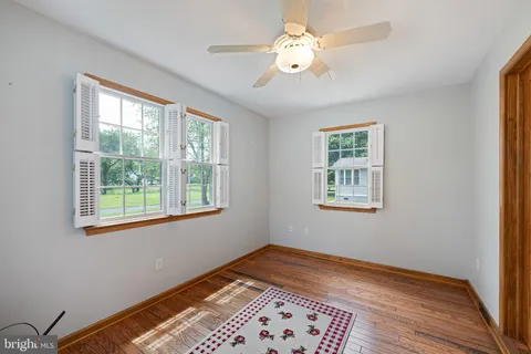 a view of a room with a window and wooden floor