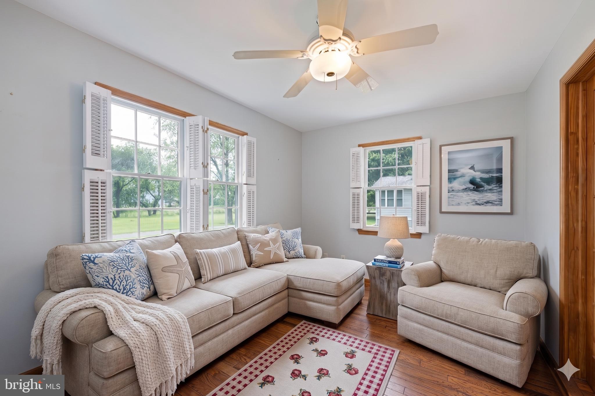 485 Bethany Loop Bethany Beach, DE 19930 - Photo 19 of 40 a living room with furniture ceiling fan and a window