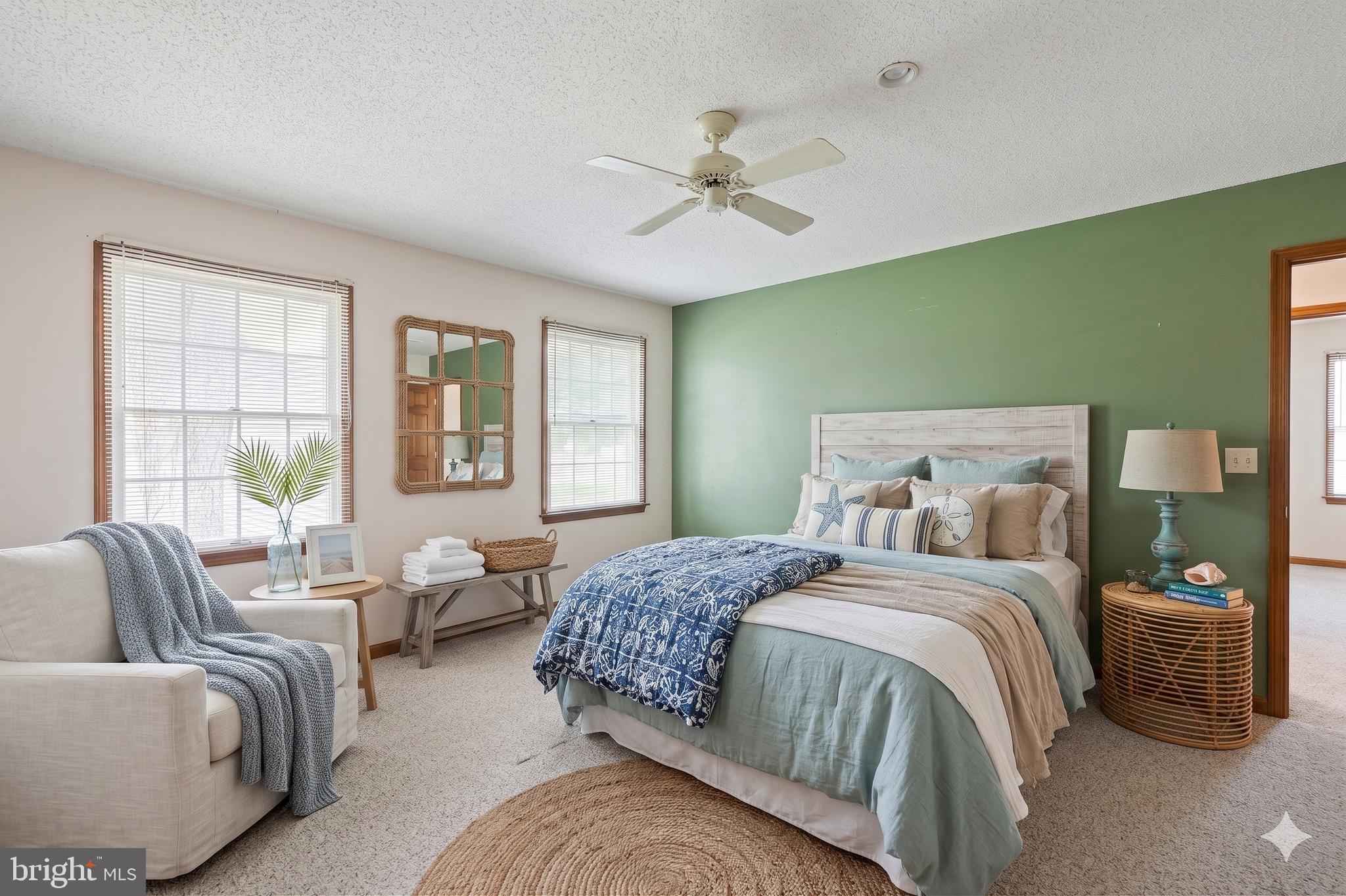 485 Bethany Loop Bethany Beach, DE 19930 - Photo 21 of 40 a bedroom with a bed couches and windows