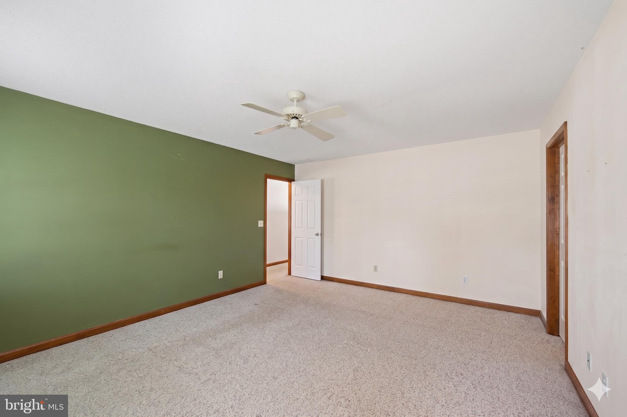 485 Bethany Loop Bethany Beach, DE 19930 - Photo 23 of 40 an empty room with a ceiling fan and a window