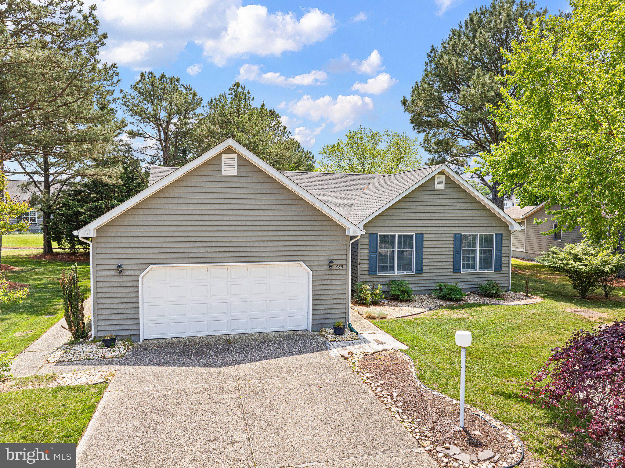485 Bethany Loop Bethany Beach, DE 19930 - Photo 3 of 40 a view of front of house with a yard and garage