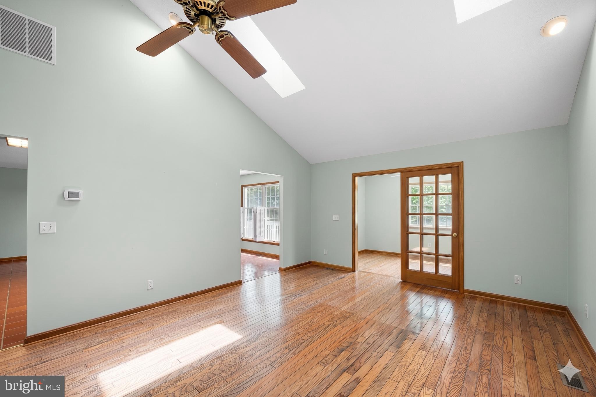 485 Bethany Loop Bethany Beach, DE 19930 - Photo 7 of 40 wooden floor in an empty room with a window