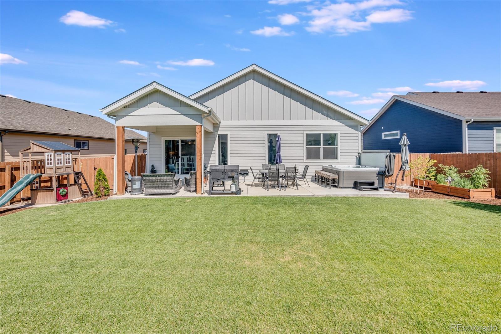 1122 Johnson Street Wiggins, CO 80654 - Photo 11 of 37 a view of a house with furniture and a yard