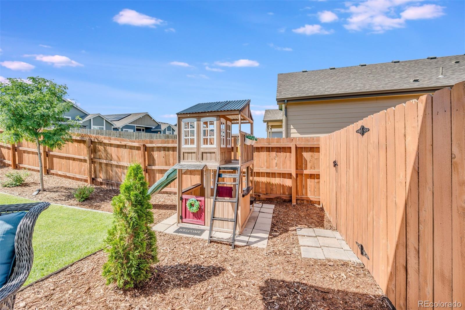 1122 Johnson Street Wiggins, CO 80654 - Photo 12 of 37 a view of a patio with table and chairs and potted plants
