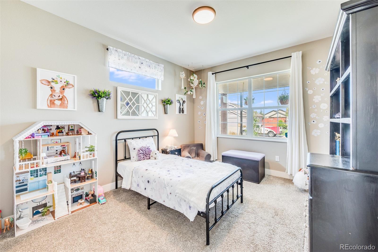 1122 Johnson Street Wiggins, CO 80654 - Photo 15 of 37 a bedroom with a bed and a window