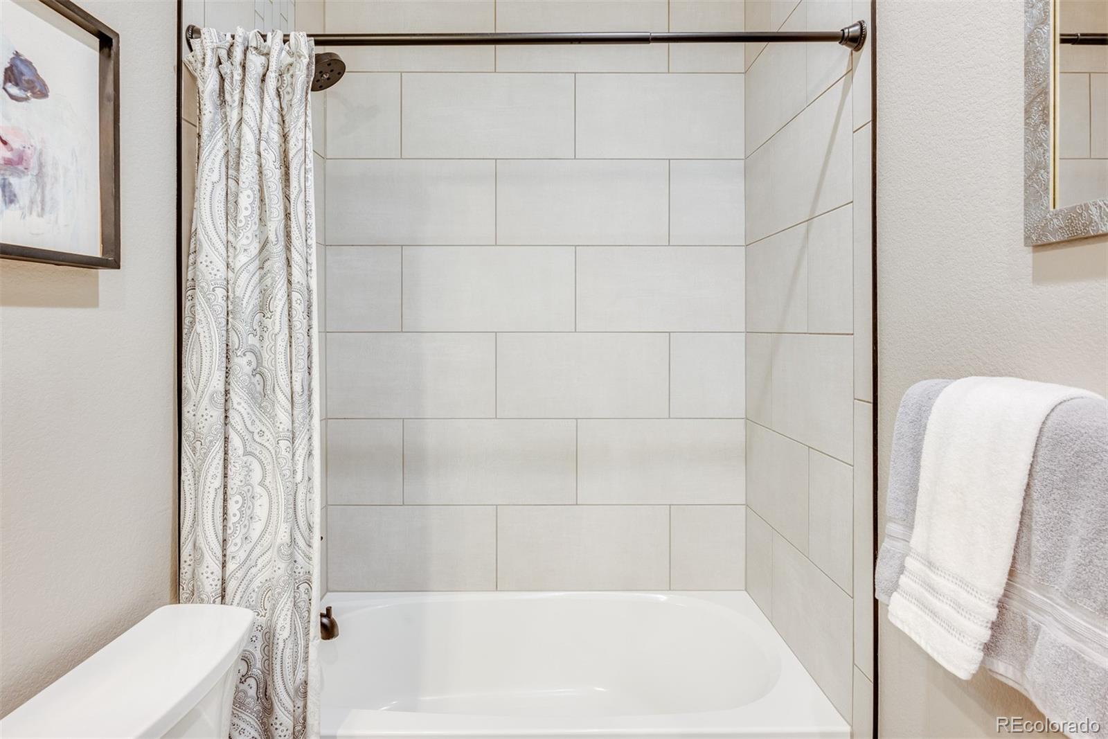 1122 Johnson Street Wiggins, CO 80654 - Photo 16 of 37 a bathroom with a shower and a toilet