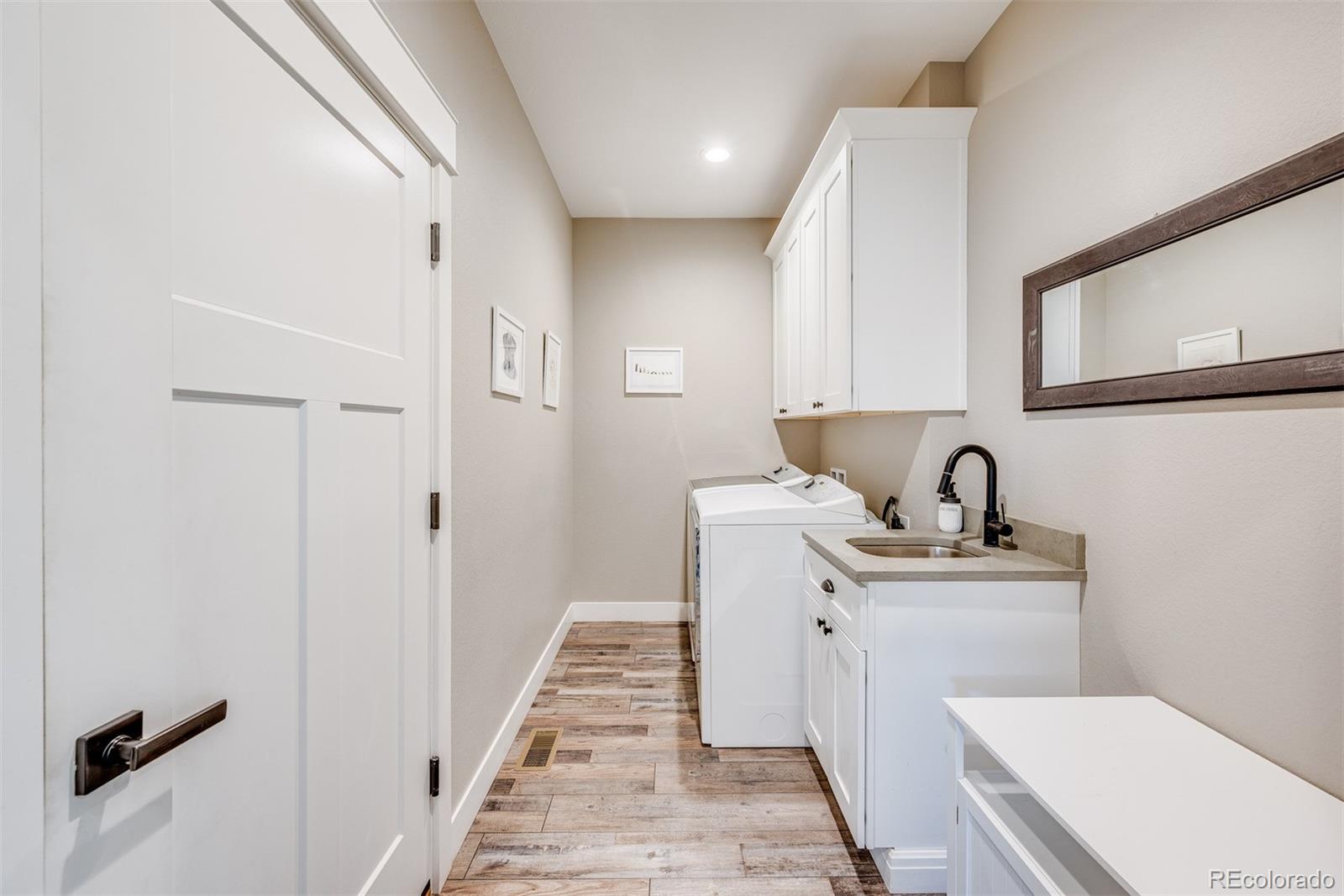 1122 Johnson Street Wiggins, CO 80654 - Photo 21 of 37 a bathroom with a sink a toilet and a mirror