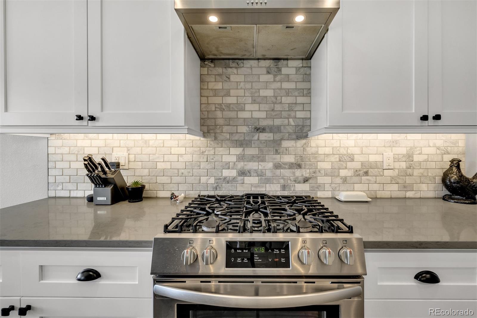 1122 Johnson Street Wiggins, CO 80654 - Photo 28 of 37 a stove top oven sitting inside of a kitchen