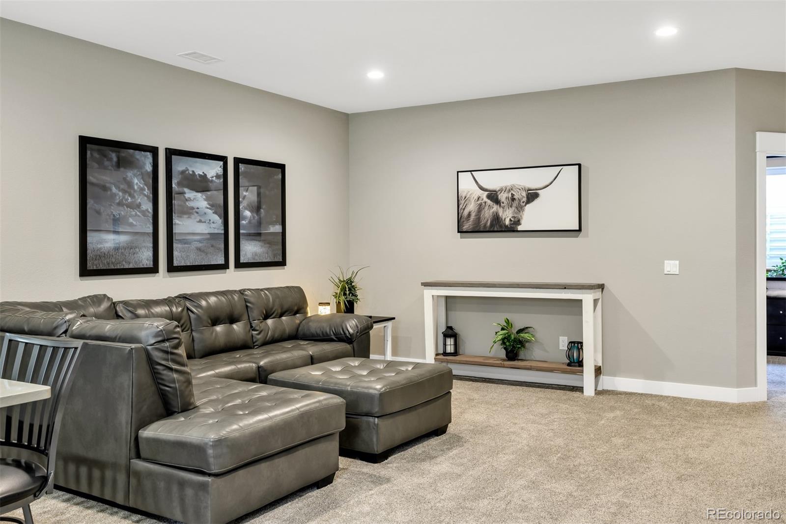 1122 Johnson Street Wiggins, CO 80654 - Photo 34 of 37 a living room with furniture and a fireplace