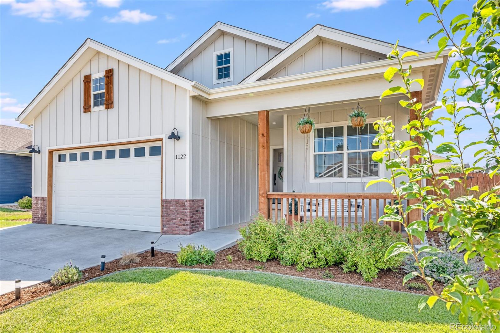 1122 Johnson Street Wiggins, CO 80654 - Photo 7 of 37 a front view of a house with garden
