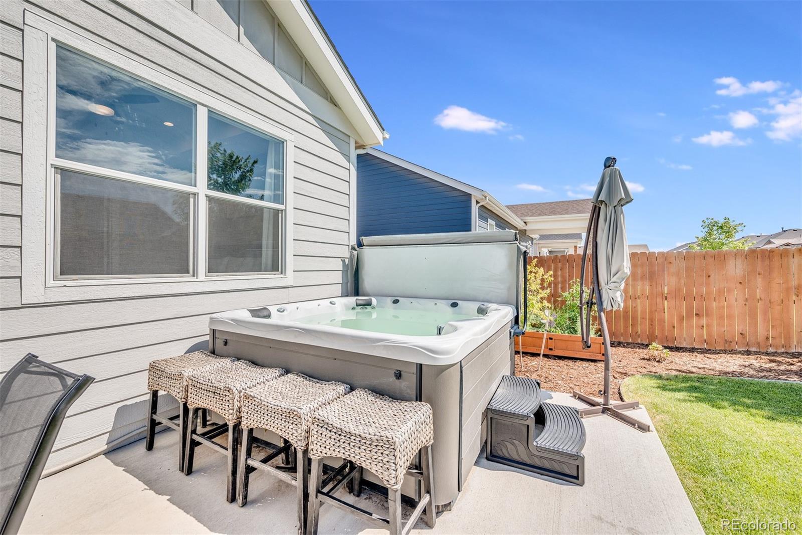 1122 Johnson Street Wiggins, CO 80654 - Photo 10 of 37 a balcony with table and chairs