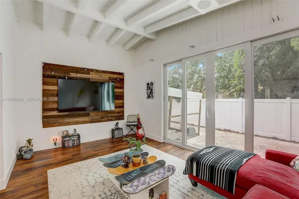 a bedroom with furniture and a flat screen tv