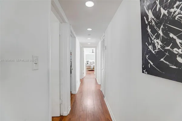 a view of a hallway with wooden floor