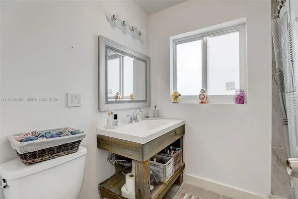 a bathroom with a sink vanity and a mirror