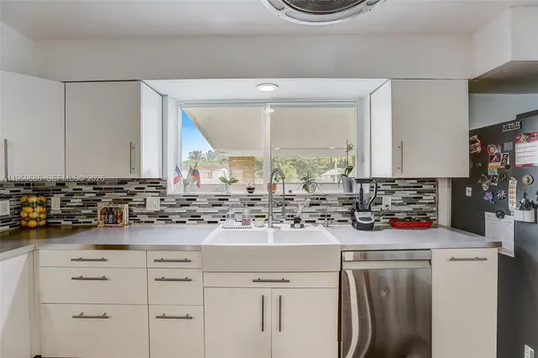 a kitchen with a sink stove and cabinets