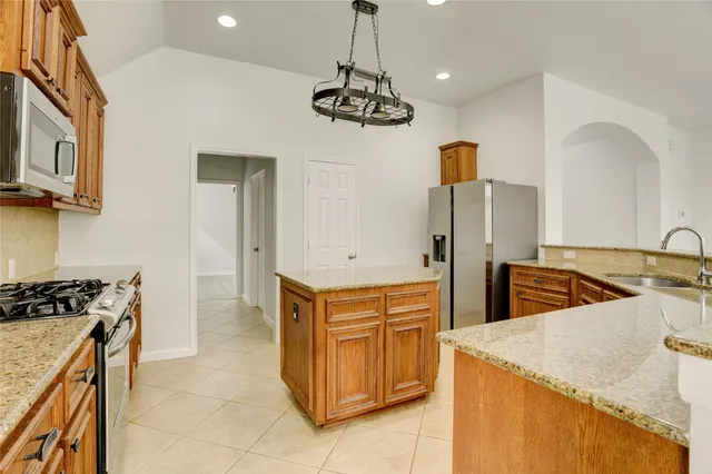 a kitchen with a stove and a refrigerator
