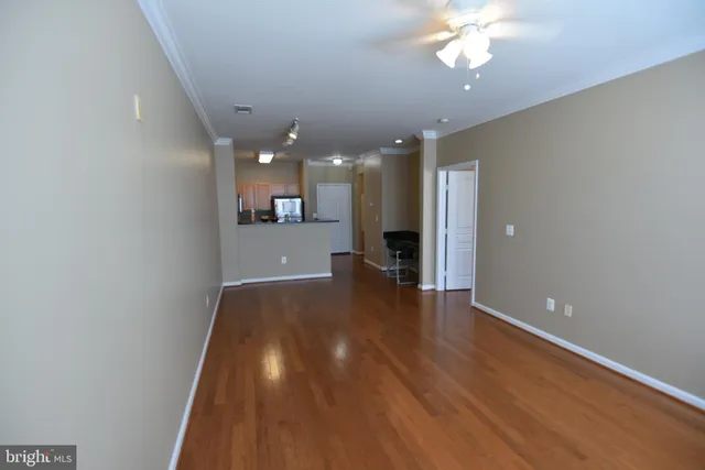 a view of a room with wooden floor