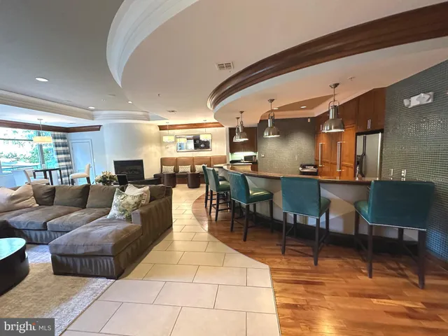 a living room with fireplace furniture and a large window