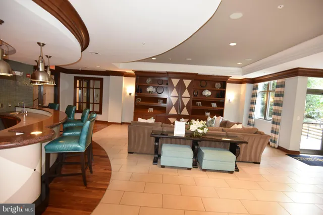 a kitchen with stainless steel appliances kitchen island granite countertop a refrigerator a stove and a sink with wooden floor