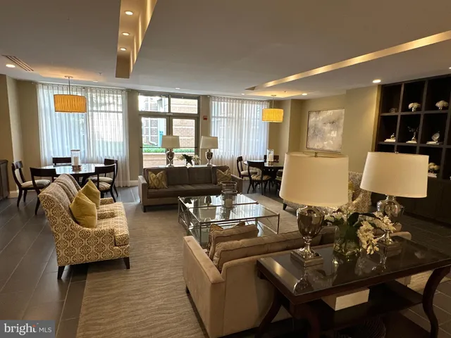 a living room with lots of furniture and a chandelier