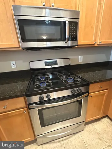 a stove top oven sitting inside of a kitchen
