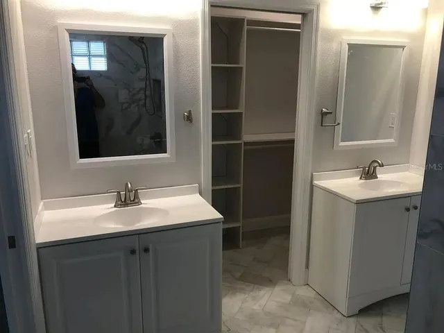 a bathroom with a sink and mirror