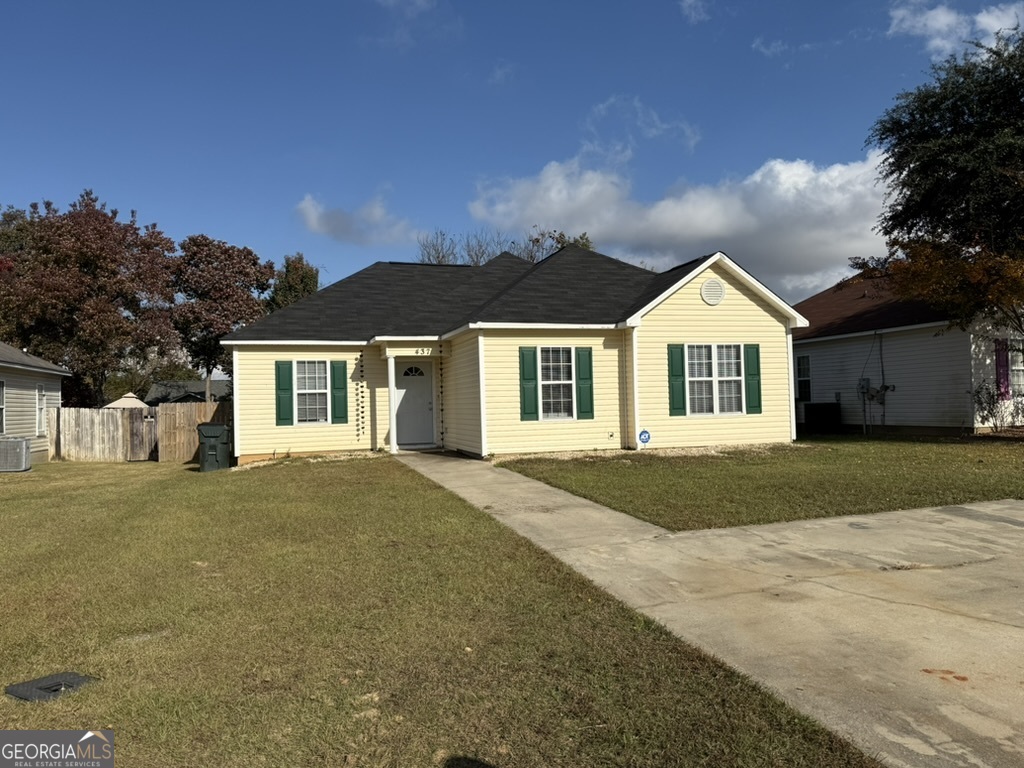 a front view of a house with a garden