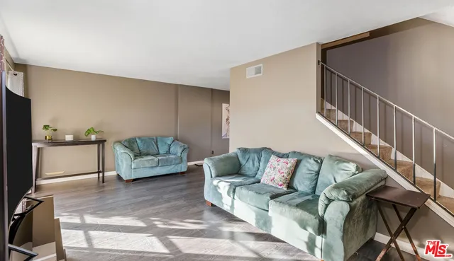 a living room with furniture and a rug