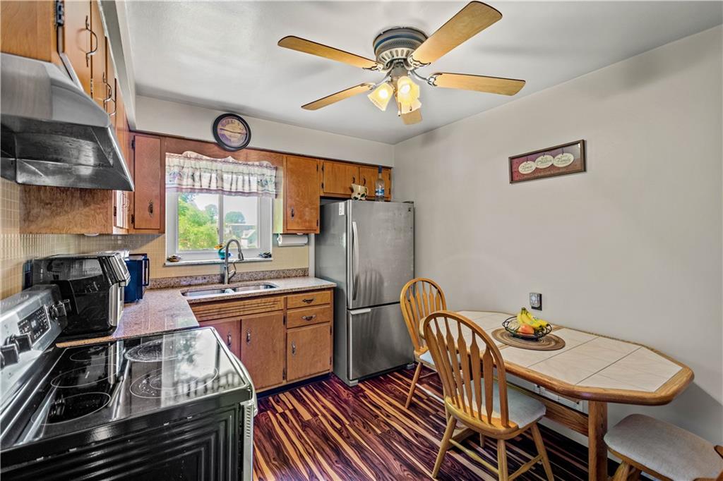 1230 Round Top Street Pittsburgh, PA 15205 - Photo 8 of 28 a kitchen with stainless steel appliances dining table and chairs