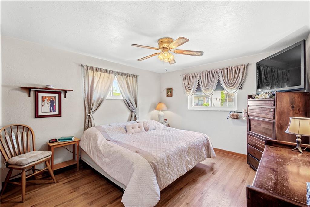 1230 Round Top Street Pittsburgh, PA 15205 - Photo 9 of 28 a bedroom with a bed and a chandelier