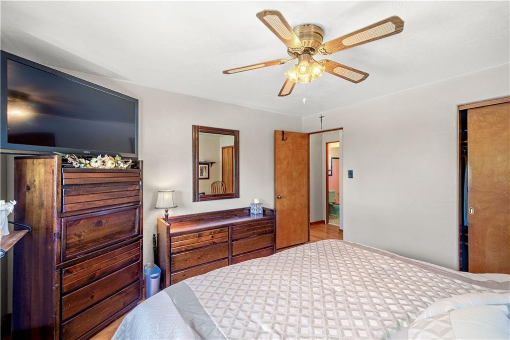 1230 Round Top Street Pittsburgh, PA 15205 - Photo 10 of 28 a bedroom with a bed and a chandelier