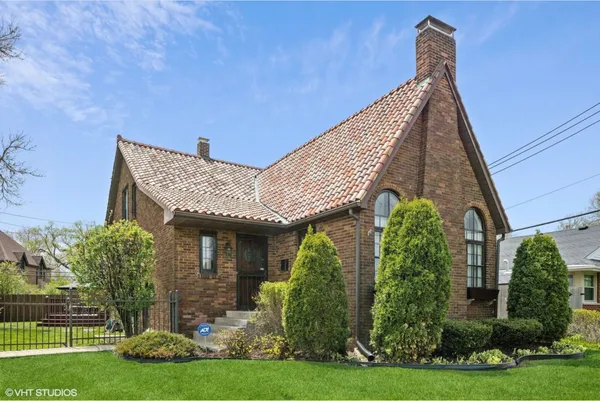 a front view of a house with a garden
