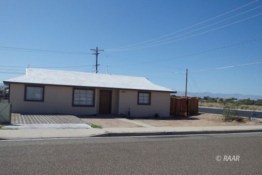437 North Fairview Street Ridgecrest, CA 93555 - Photo 2 of 35 a bedroom with a large bed and a chandelier