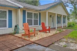 a view of a house with backyard sitting area and porch
