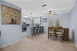 a kitchen with granite countertop a sink stainless steel appliances and window