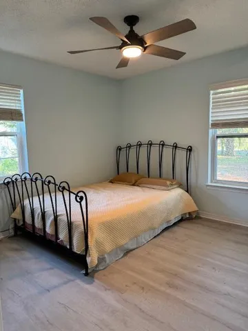 a utility room with stainless steel appliances wooden floor washer and dryer